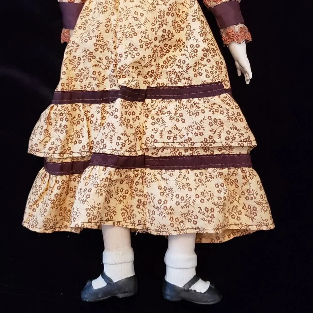Vintage Porcelain Doll with Brown Dress and Hat